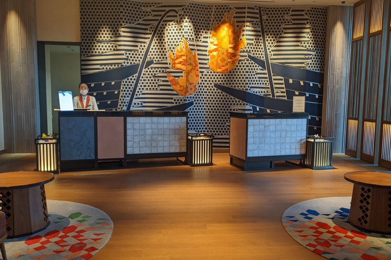 フロントのアートワークは、木曽川の鵜飼をイメージしたデザイン。犬山祭の衣装なども使われている（ホテルインディゴ犬山有楽苑）